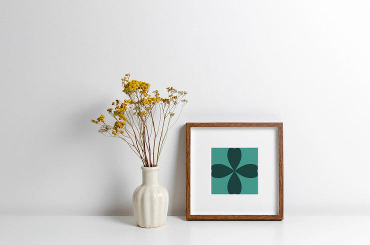 Framed Abstract Cloverleaf Wall Art featuring a dark green design with a minimalistic style