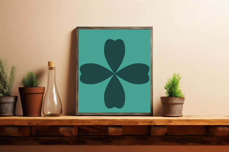 Abstract Cloverleaf Wall Art in teal and dark green, framed and displayed on a wooden shelf with plants
