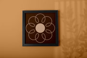 Earthy Circle in Brown poster featuring a floral design within a black frame