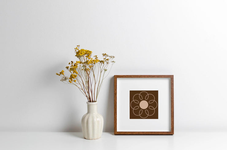 Earthy Circle in Brown framed poster displayed with dried flowers in a vase