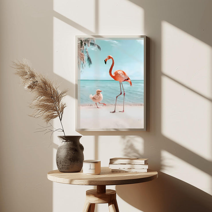 Flamingo and Chick Beach Art Print displayed on a wall with a vase and books on a table