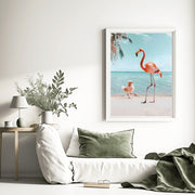 Flamingo and Chick Beach Art Print displayed in a cozy living room setting with modern decor