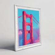 Golden Gate Bridge pink wall art in a white frame with a colorful background